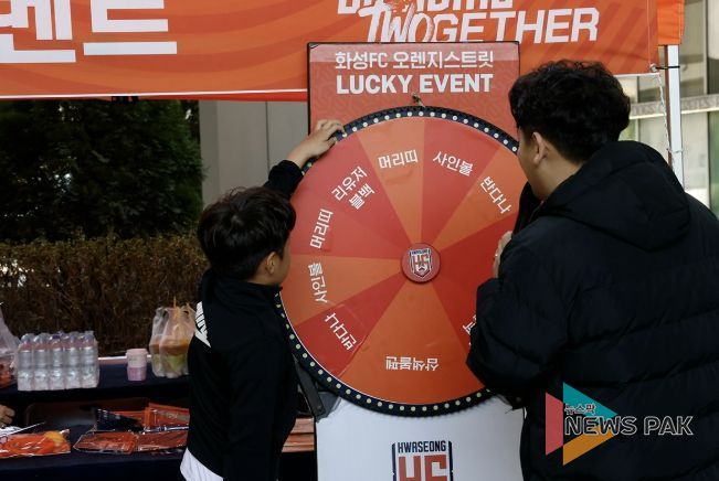 화성시민이 화성FC 게릴라 팝업 부스에서 경품 룰렛 이벤트에 참여하고 있다